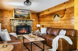 The main level living room off the kitchen is a cozy spot for the family to gather