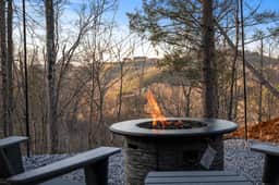Cozy fire pit with mountain views on a private wooded patio