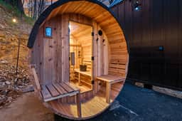 Private cedar barrel sauna by the cabin—relax under the trees