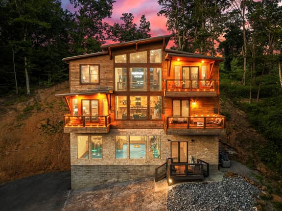 This stunning modern cabin sleeps 25 people and has lots of parking. 5 cars fit  without blocking each other in, but can fit several more if blocking other cars in.  You can also continue to park up the long driveway if needed for additional cars