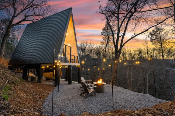 Modern A-frame with fire pit, string lights & sunset forest views